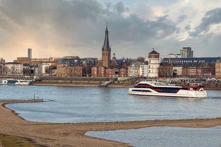 Duesseldorf embankment on warm spring evening on week-end, many people walkingのeditorial素材