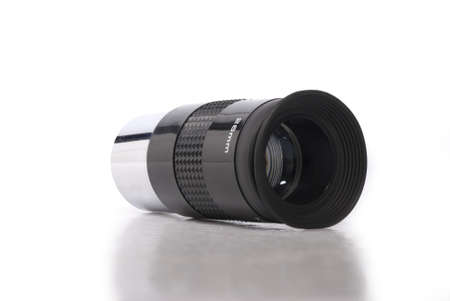 Close-up image of a black and metallic telescope eyepiece on a white background with a mild relfection/shadow beneath.の写真素材