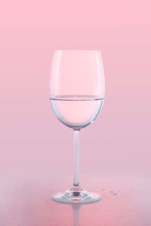 A crystal white wine glass holding water against a pink background with reflection and water drops.の写真素材