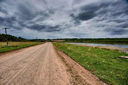 Forest dirt road in the wilderness along the river. High quality photoの写真素材