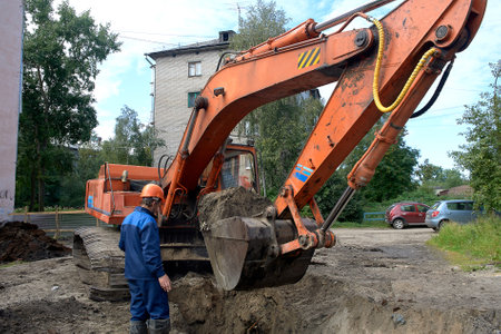 Excavator performs earthworks in the city