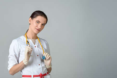 a young doctor in a white coat with a stethoscopeの写真素材