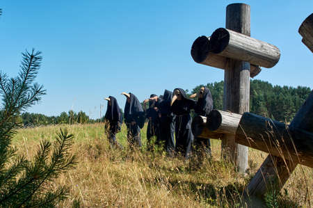 a group of people are standing in the masks of the plague doctorの写真素材