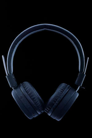 black wireless headphones on a black backgroundの写真素材