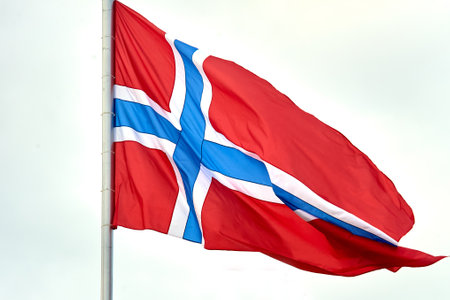 The flag of Norway hangs on the flagpole