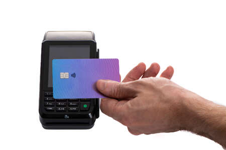 Attached plastic card to the payment terminal with a mans hand on a white isolated background