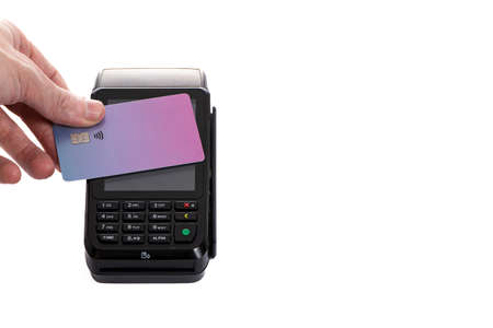 a payment terminal with a plastic card attached to it on a white isolated background close-up, copy spaceの写真素材