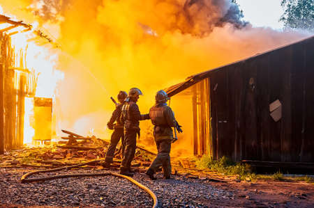 Firefighters extinguish a fire in a farm buildingの写真素材