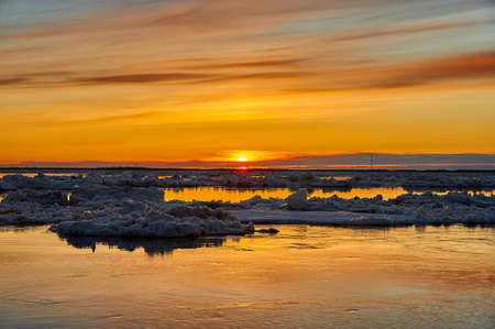 Sunset on the river during an ice drift