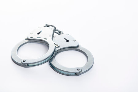 Metal handcuffs on a white isolated background, copy spaceの写真素材
