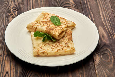 delicious juicy pancakes lie on a white plateの写真素材