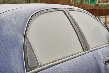 frozen windshield of a passenger car in winterの写真素材