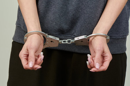 womens hands are handcuffed in close-up