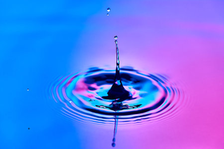 a drop of water falling into the water and creating wavesの写真素材