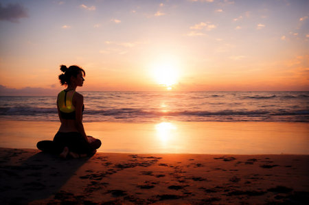 Young woman practicing yoga on the beach at sunset. Yoga concept.の素材