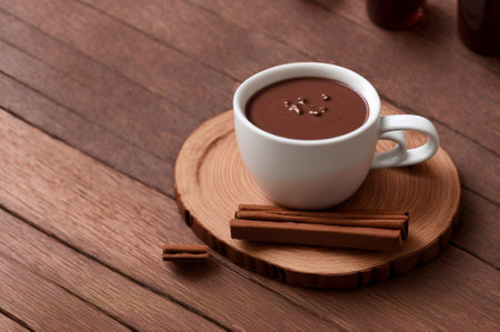 cup of hot chocolate with cinnamon on a wooden table, top viewの素材