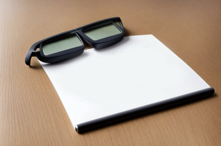 Blank paper with eyeglasses on the wooden table background.の素材