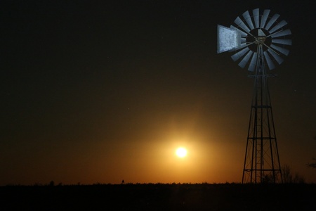 A windmill in bright moonlight in namibiaの写真素材