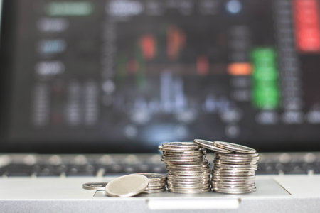 silver coin and laptop keyboardの写真素材