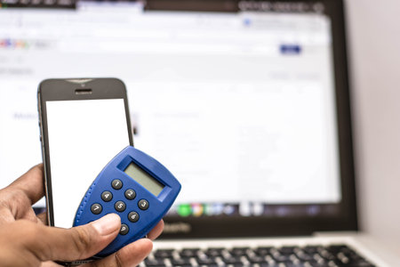 smartphone and atm or credit cards with laptop monitor screen