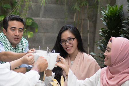 group of young asian muslim having toast during ramadan celebration