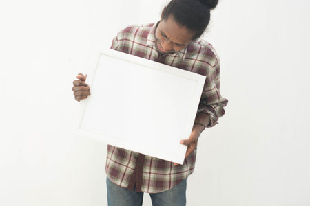 young black man pointing white board with isolated background in white