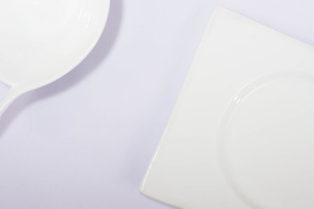 Flat lay of white plate, bowl, isolated in white or purple fabric, simple minimalist template...