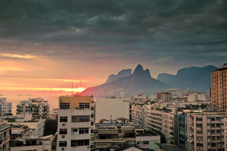 view over tops of residential buildings and mountains at sunset in Ipanema Rio de Janeiro Brazil