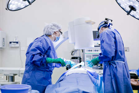 Surgeon and nurse in operating theatreの写真素材