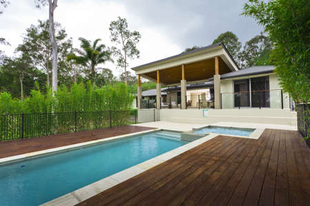 Modern backyard with swimming pool and outdoor entertaining area in Australian mansion