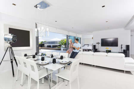 Attractive couple with champagne bottle in luxury apartment