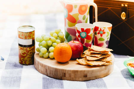 picinic setting with fresh fruit and snacksの写真素材