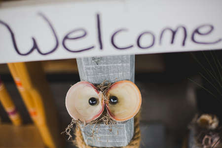 cute hand made welcome sign with shell that look like eyesの写真素材