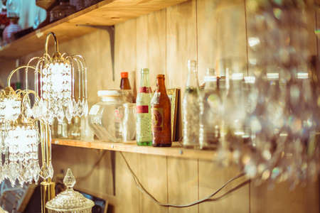 cluttered shelf with bottles and containers in vintage shopの写真素材
