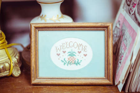 Vintage framed welcome cross stichの写真素材