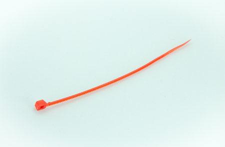 A Red Nylon Cable Ties on White Backgroundの写真素材