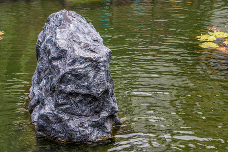 Big black stones in water garden backgroundの写真素材