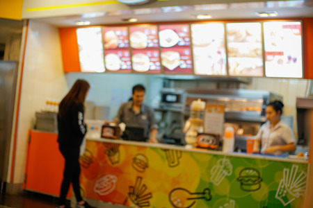 Abstract blurred people buy food in burger and coffee shop cafe for backgroundの写真素材