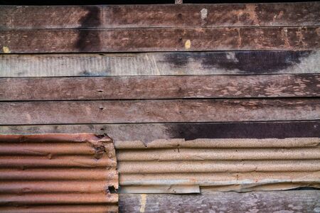Rusty corrugated metal wall or rusty Zinc grunge and wood plank for backgroundの写真素材