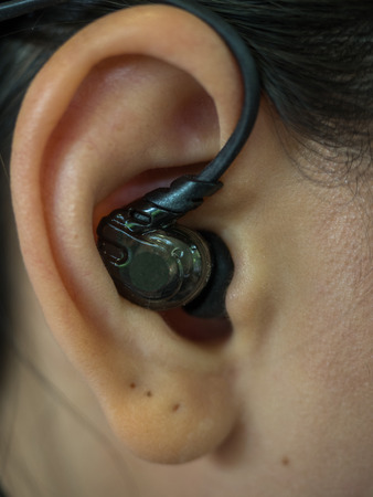 Close up of black headphone in earの写真素材