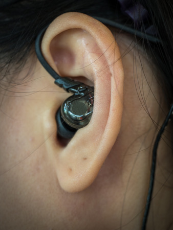 Close up of black headphone in earの写真素材