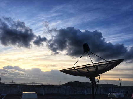 Satellite network communications technology on sky sunrise at dawn.の素材
