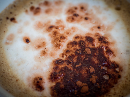 Cappuccino with milk froth, sprinkle with coffee powderの写真素材