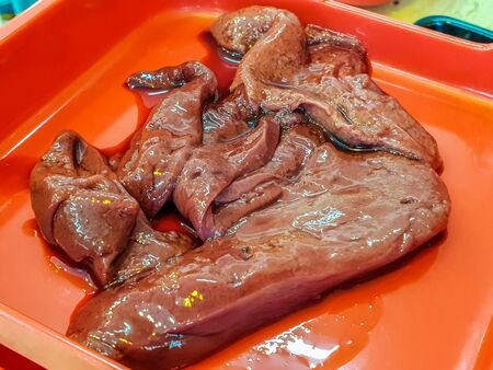 Fresh and tasty liver on the red plate