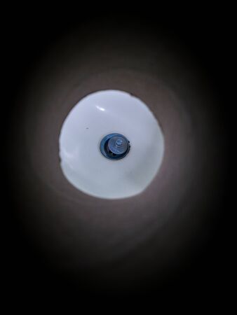Abstract Silver rusty sink hole in the white ceramic sin, lowkeyの写真素材