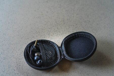 The Mini cases for safe transport headphones on the floorの写真素材
