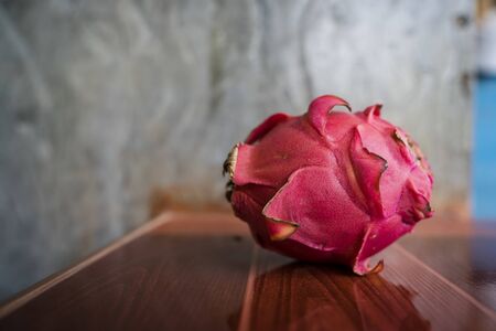 A Dragon fruit. (tropical fruit) on wooden backgroundの写真素材