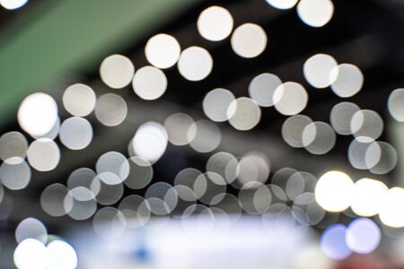 The colorful bokeh lights from vehicles on the road with traffic in dark night , in vintage film...
