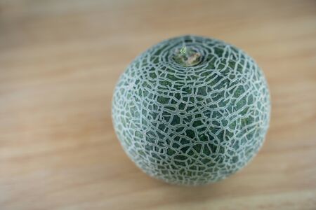 selected focus of A fresh green Melon on wooden backgroundの写真素材