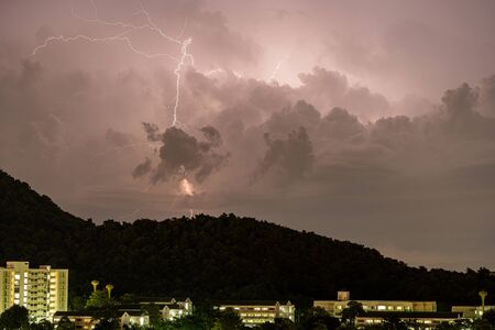 The Storm lightning strikes in mountains during a thunderstorm at night. Beautiful dramatic viewの写真素材